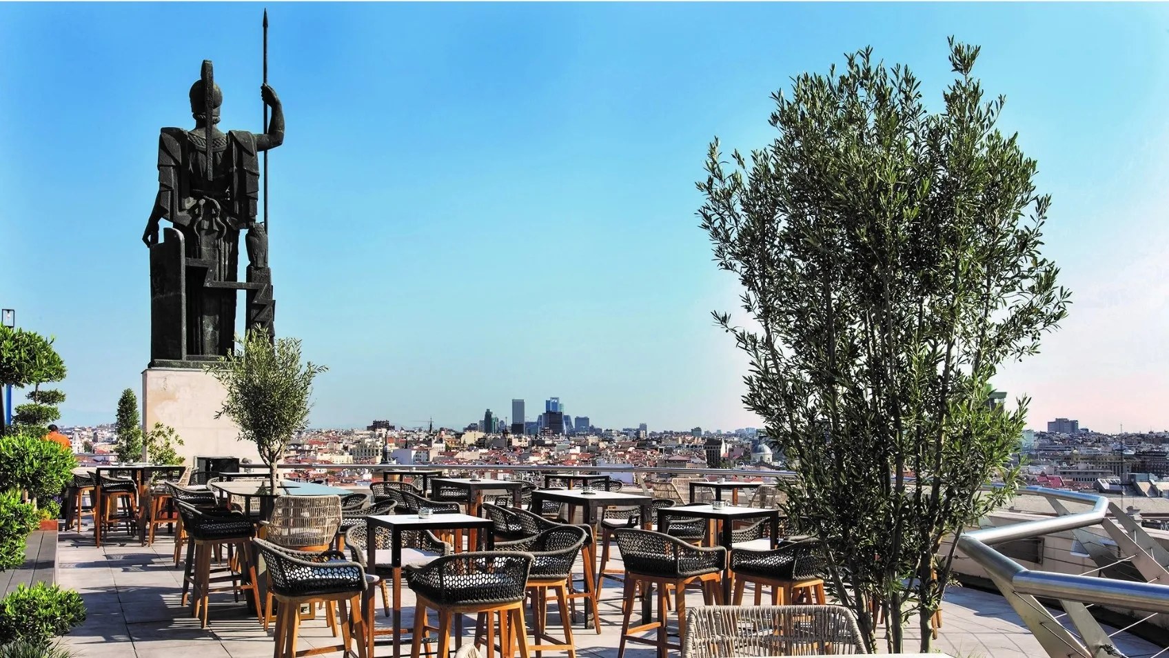 The rooftop terrace of the Circulo de Bellas Artes in Madrid, with the Minerva statue and tables looking over the city