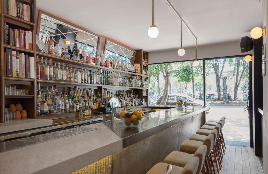 The bar at Licoreria Limantour in Roma Norte, with bottles shelved to the ceiling