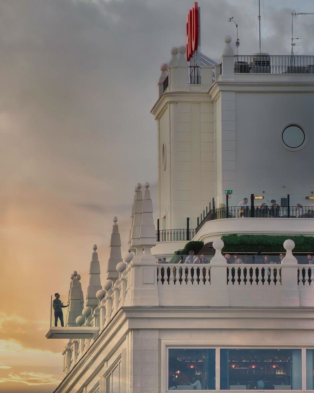 The glass viewing platform projecting from the roof of the Riu Plaza Espana in Madrid at sunset