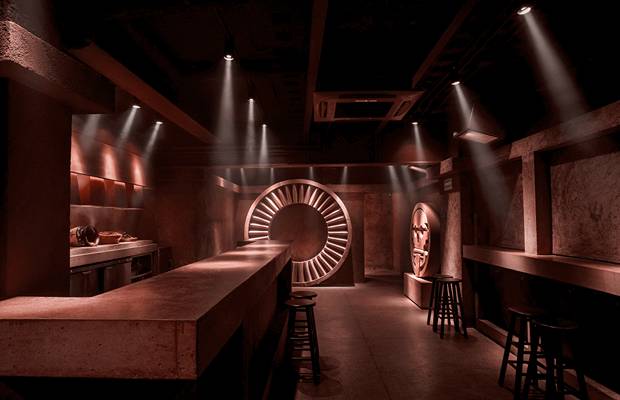 The deep red interior of Tlecan in Roma Norte, lit around a circular feature behind the bar